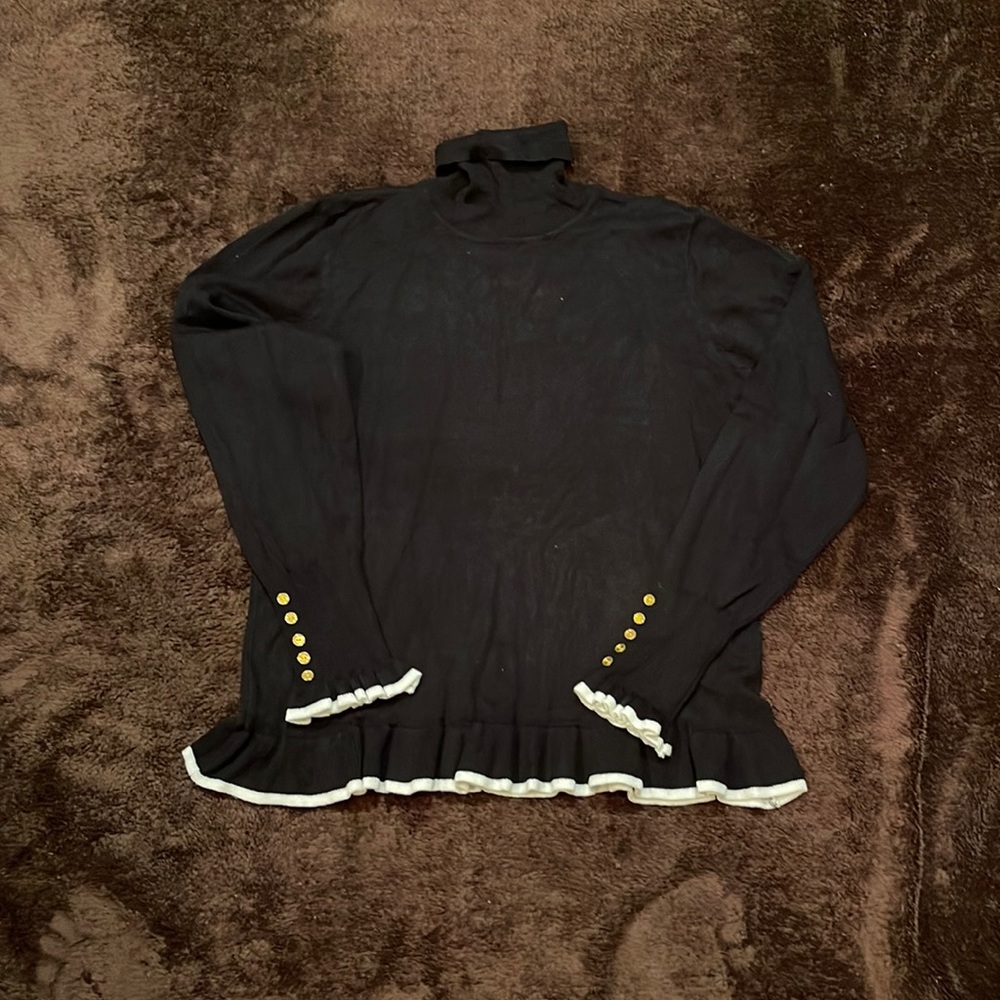 Black cotton blend turtle neck sweater with white ruffle trim. Size medium.